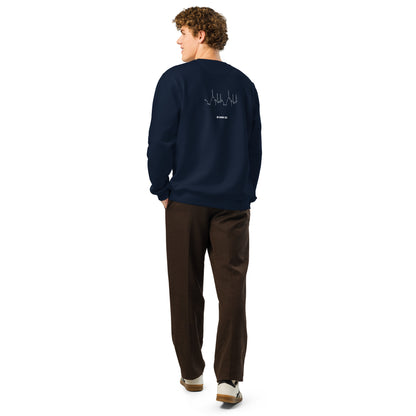 Person wearing a navy sweatshirt with custom Strava route print art on the back, standing against a white background