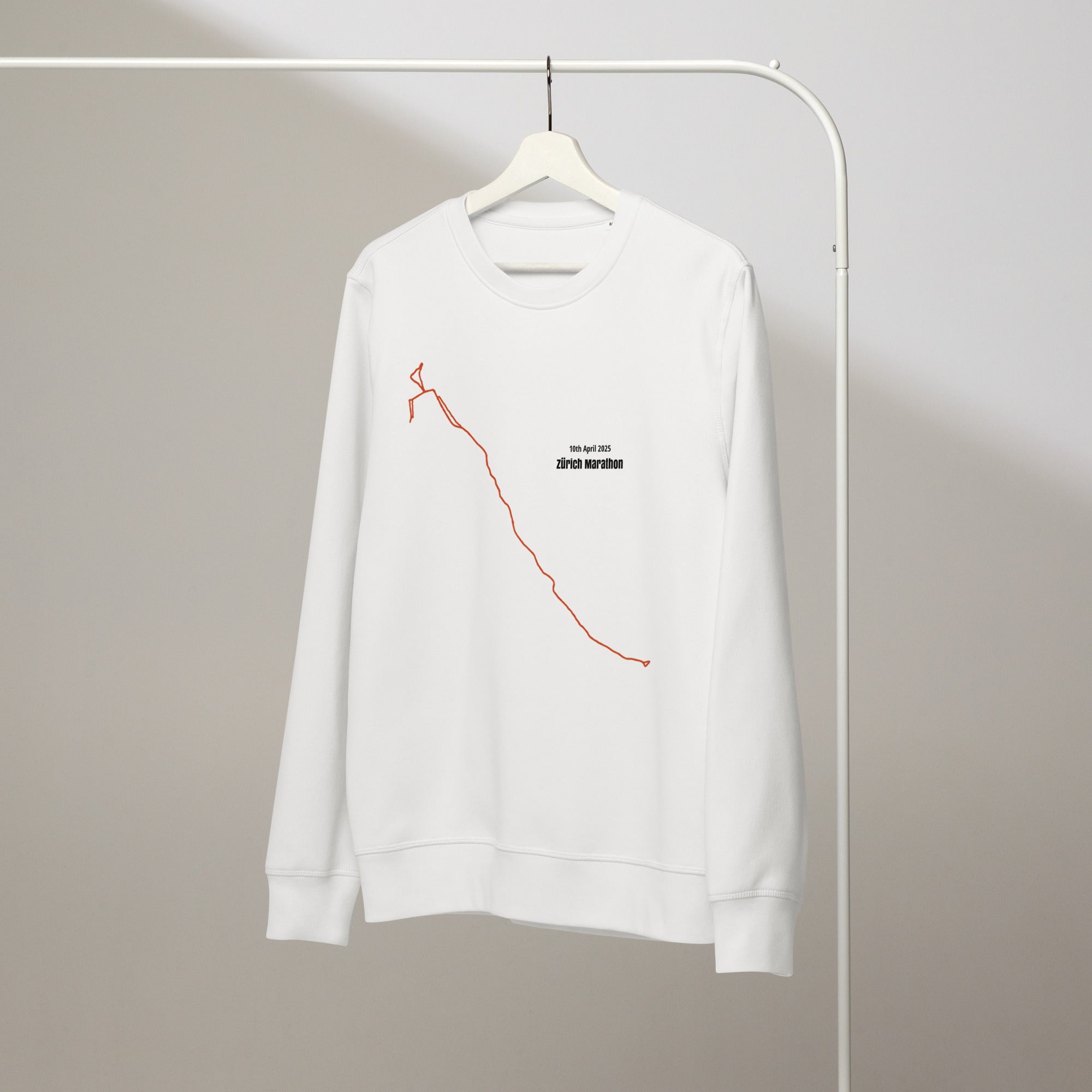 White sweatshirt with red custom Strava route print art design on a hanger against a plain background