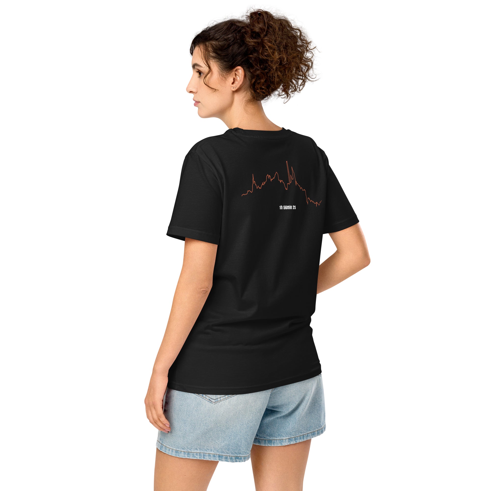 Woman wearing a black t-shirt with a custom Strava route print art design on the back, standing against a white background