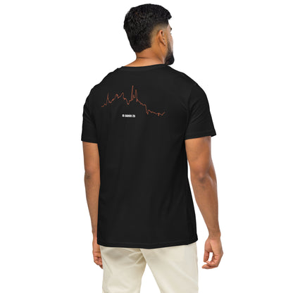 Man wearing a black t-shirt with a custom Strava route print art design on the back, standing against a white background