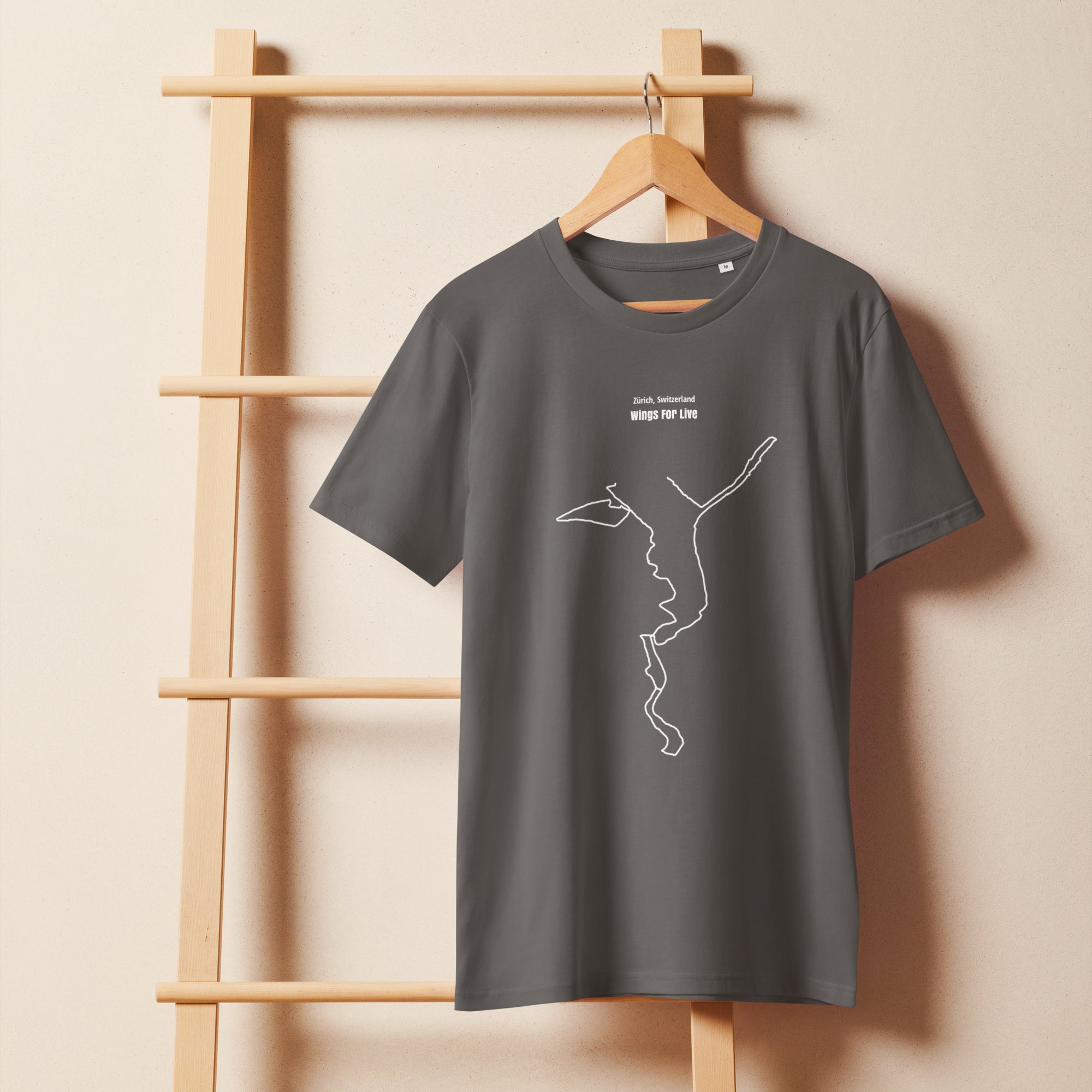 Gray t-shirt with a white custom Strava route print art design on a wooden hanger against a beige wall