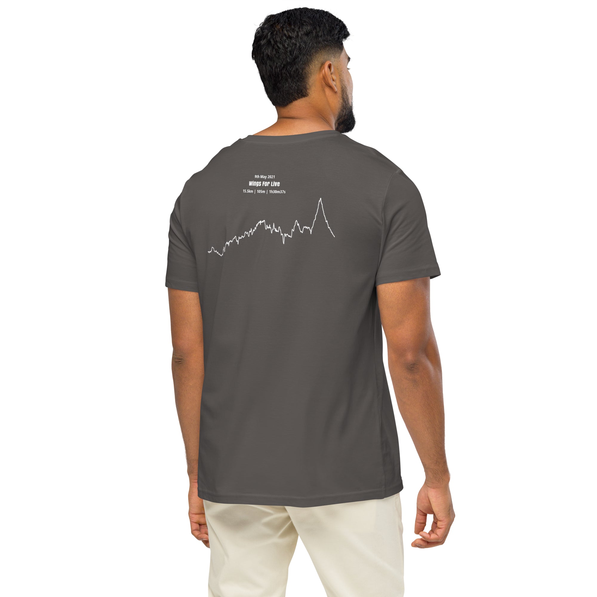 Man wearing a dark gray t-shirt with a custom Strava route print art design on the back, standing against a white background
