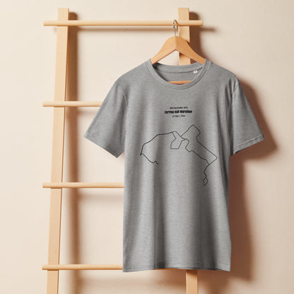 Gray t-shirt with a custom Strava route print art design on a wooden hanger against a beige wall