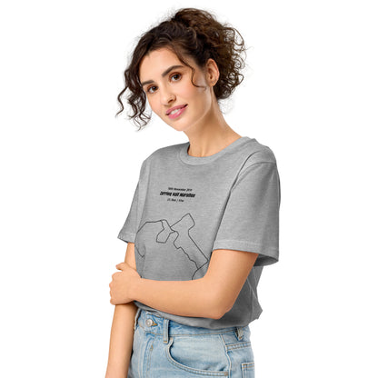 Woman wearing a gray t-shirt with a custom Strava route print art design on a white background