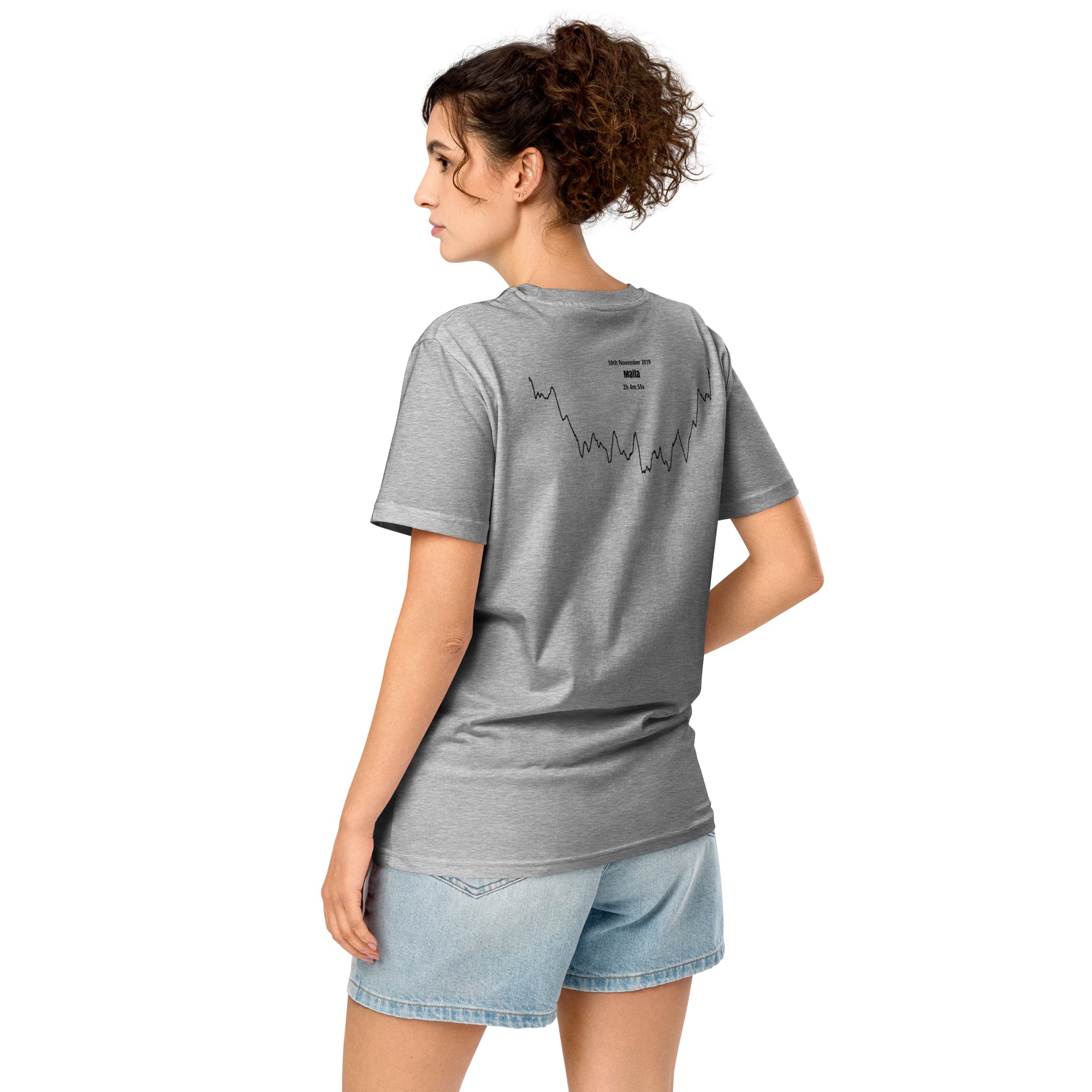 Woman wearing a gray t-shirt with a custom Strava route print art design on the back, standing against a white background