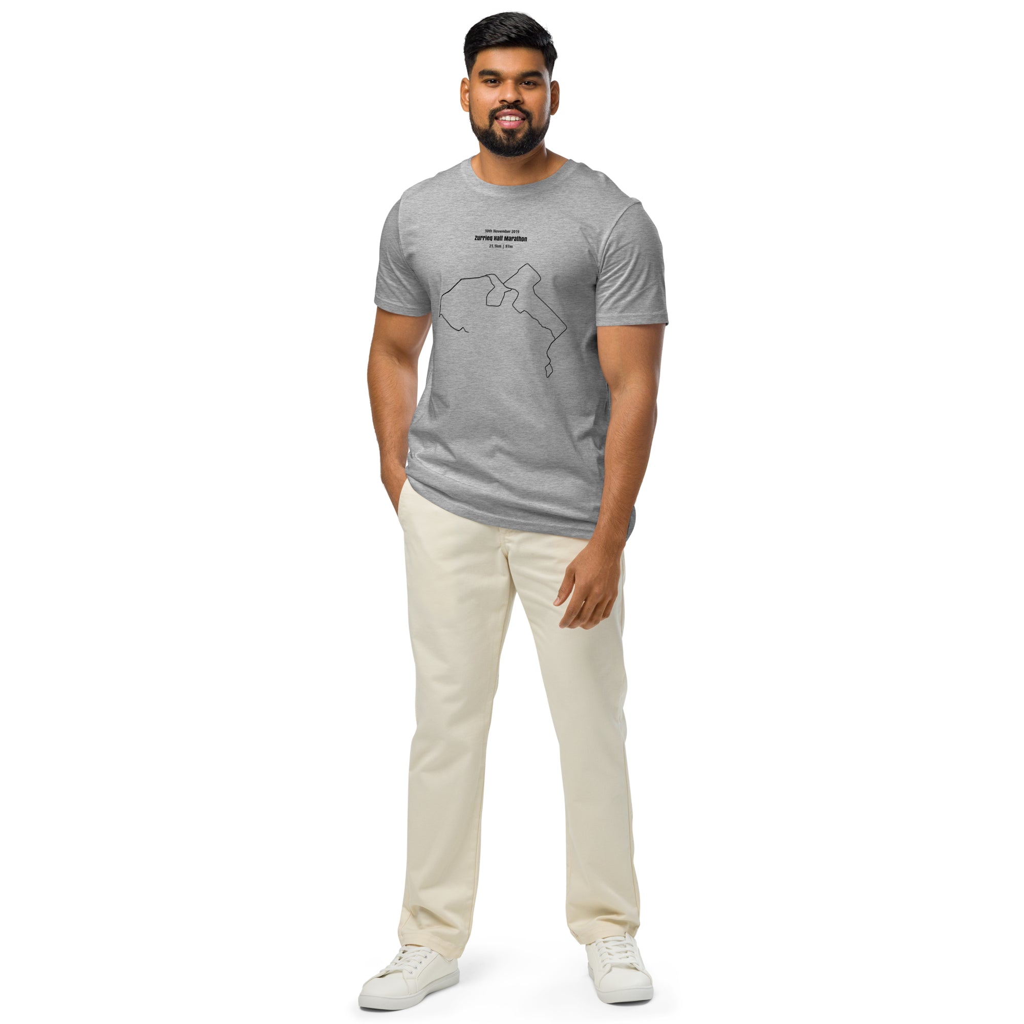 Man wearing a gray t-shirt with a custom Strava route print art design and beige pants on a white background