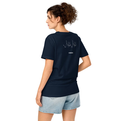 Woman wearing a navy blue t-shirt with a custom Strava route print art design on the back, standing against a white background