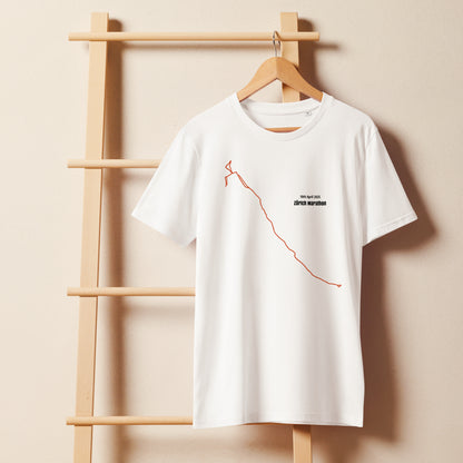 White t-shirt with a custom Strava route print art design on a wooden hanger against a beige wall