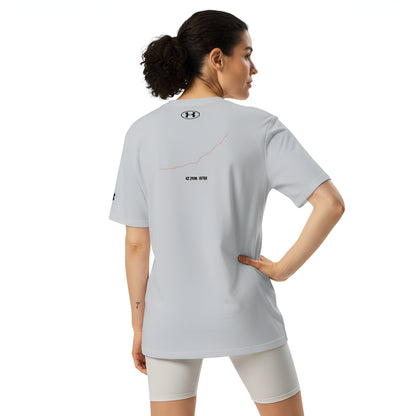 Woman wearing a light gray sports outfit with a brand logo and custom Strava route print on a white background