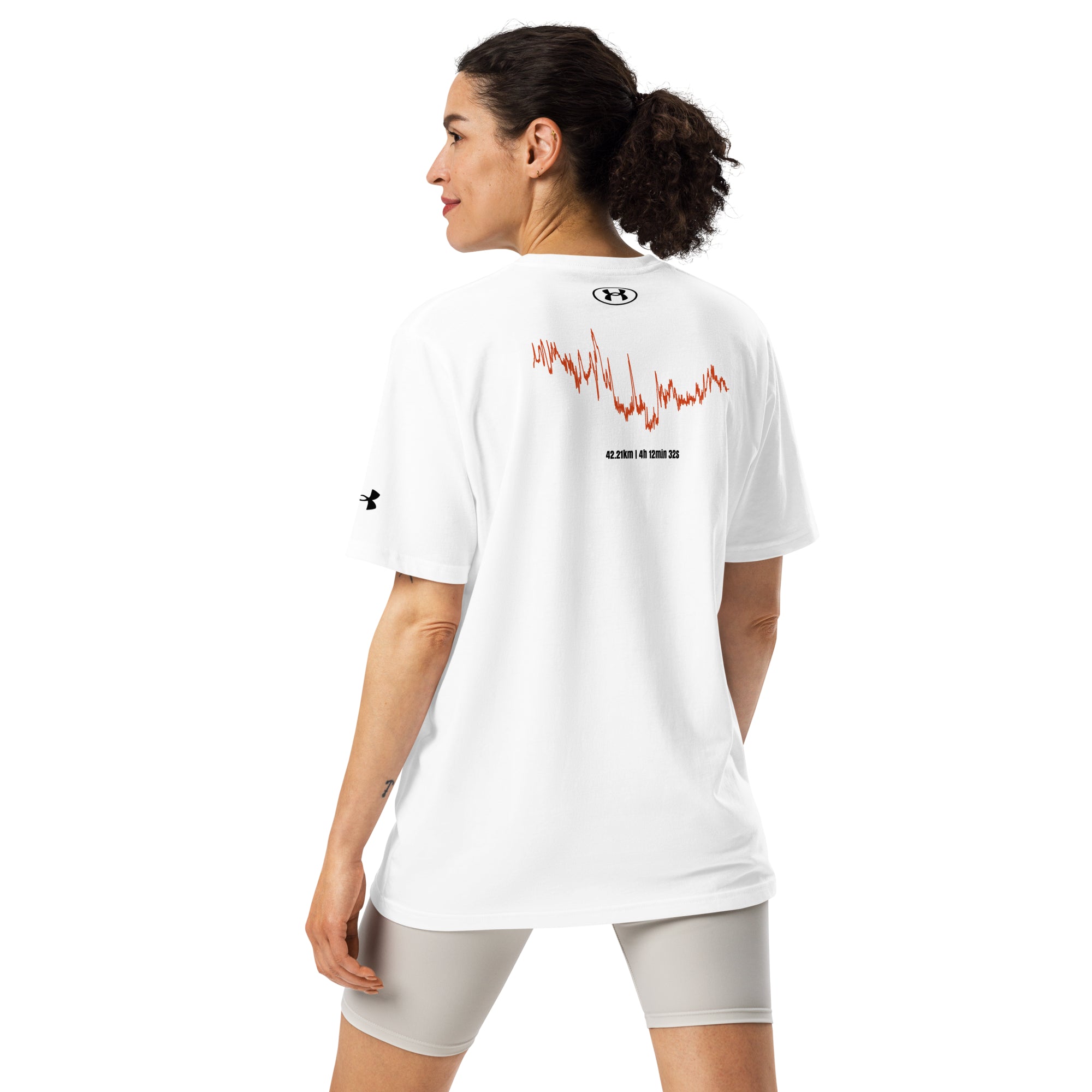 Woman wearing a white Under Armour shirt with red custom Strava route print design on the back, standing against a white background