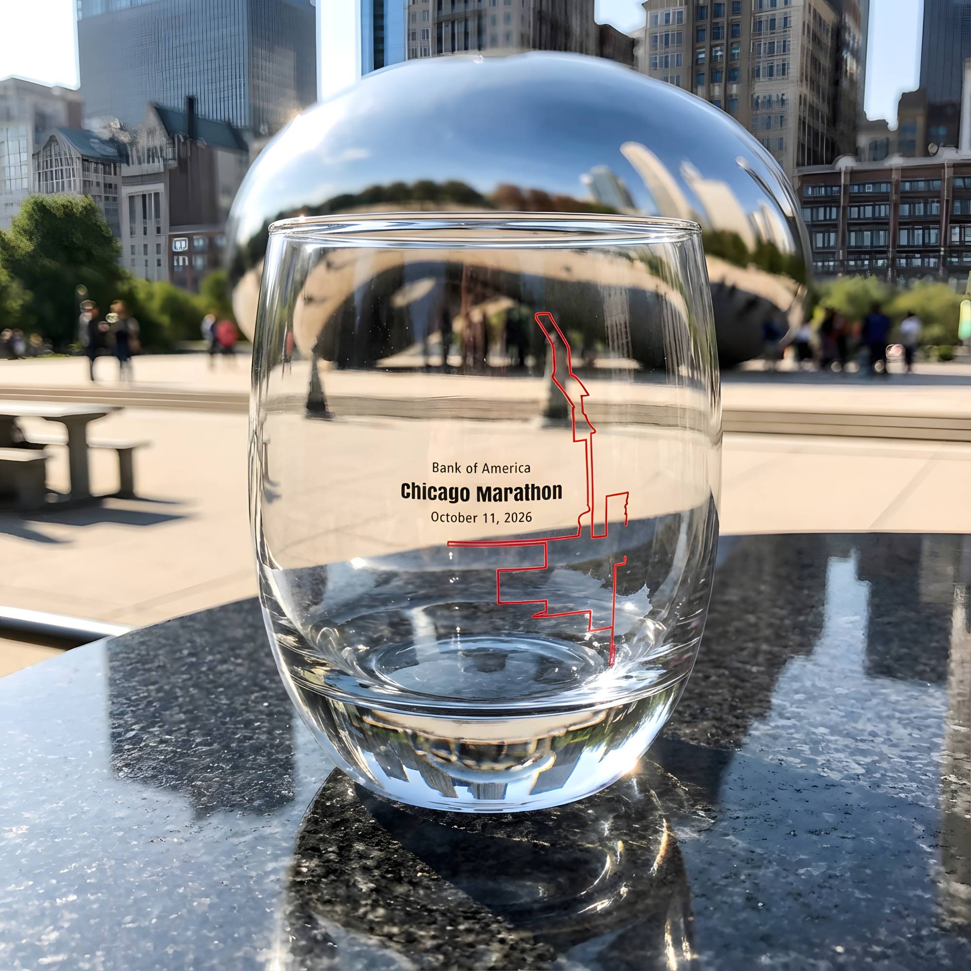 Clear glass with marathon custom Strava route print art design in front of a reflective surface with cityscape of Chicago background
