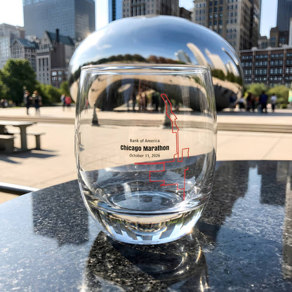 Clear glass with marathon custom Strava route print art design in front of a reflective surface with cityscape of Chicago background